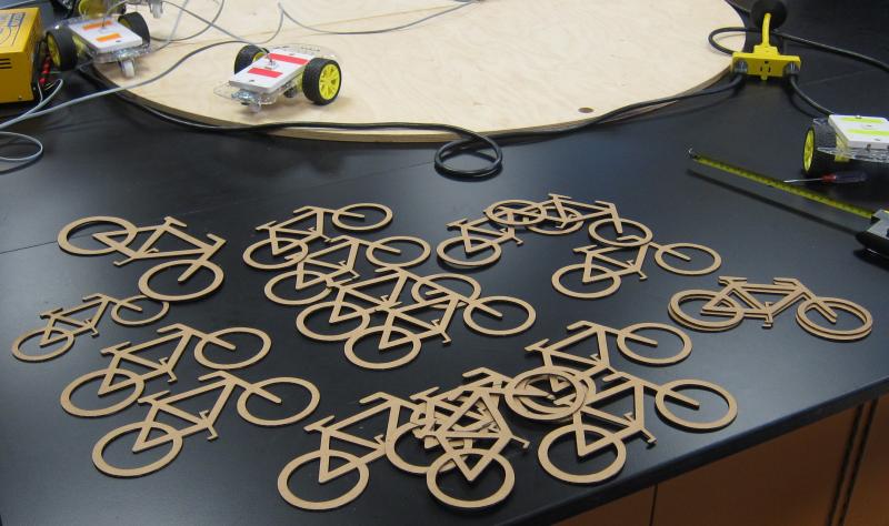 Laser cut cardboard bikes.